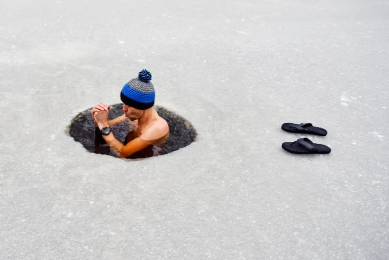 incorporate cold therapy into your life with wim hof method and young man in cold water